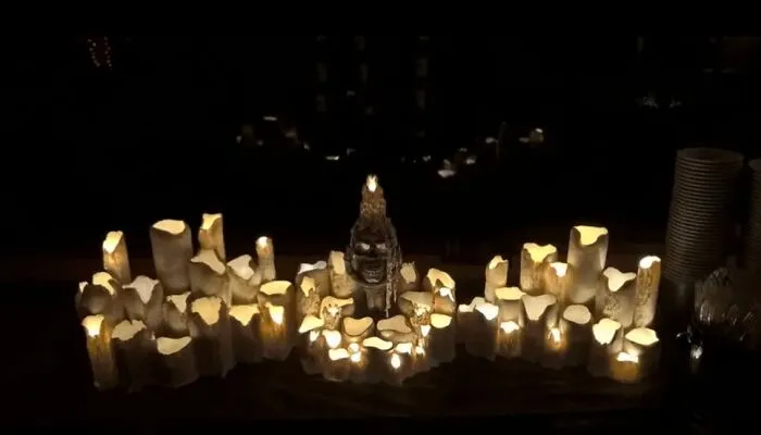Glowing melted candle display surrounding a skull for atmospheric Halloween home decor