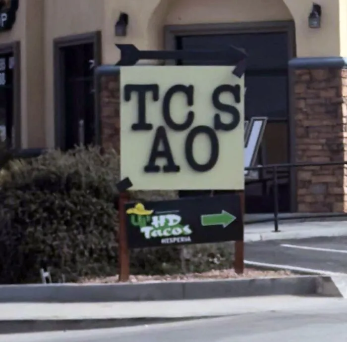 A confusing outdoor sign displaying scrambled letters in a terribly designed signs fail.