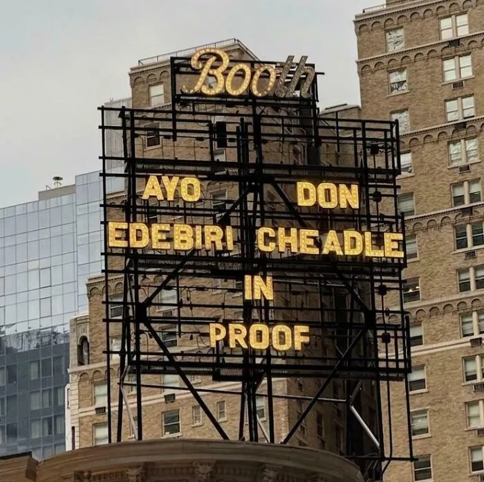 A theater marquee with confusingly arranged actor names, featuring terribly designed signs.