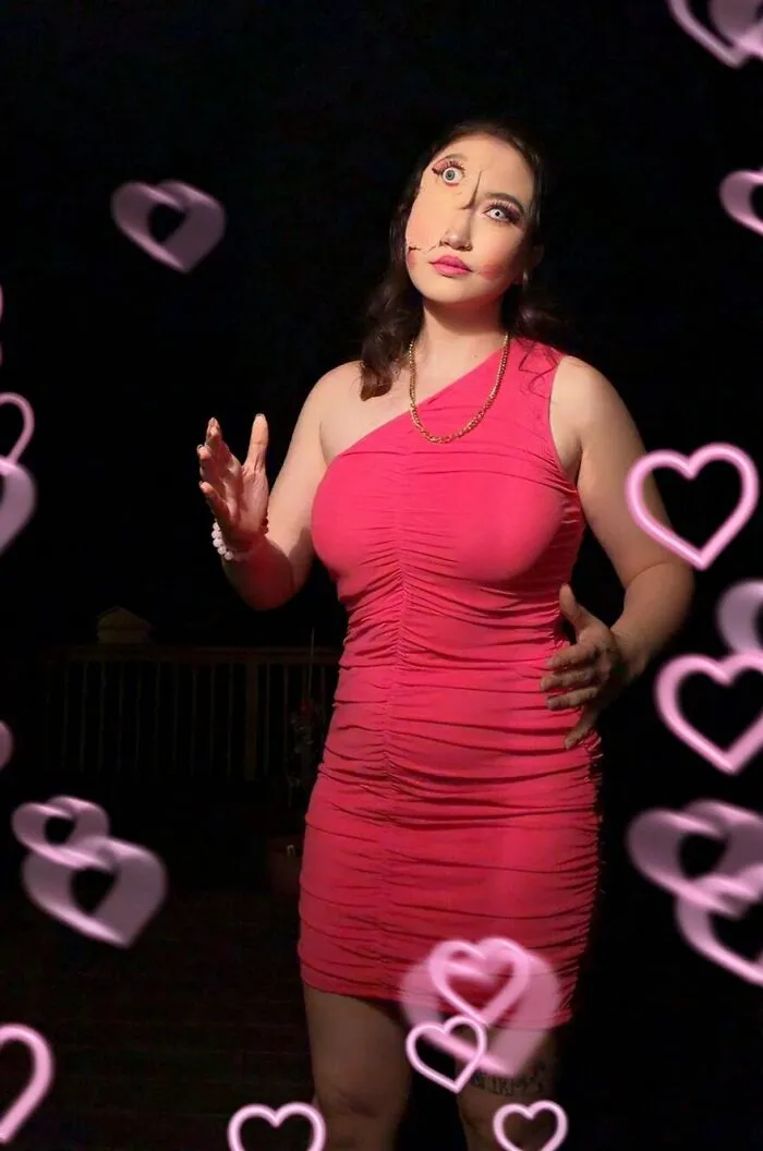 Woman with illusion makeup for creative Halloween costume ideas in a pink dress