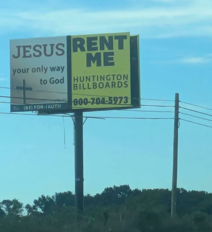 A roadside billboard with poorly aligned text layout showing terribly designed signs.