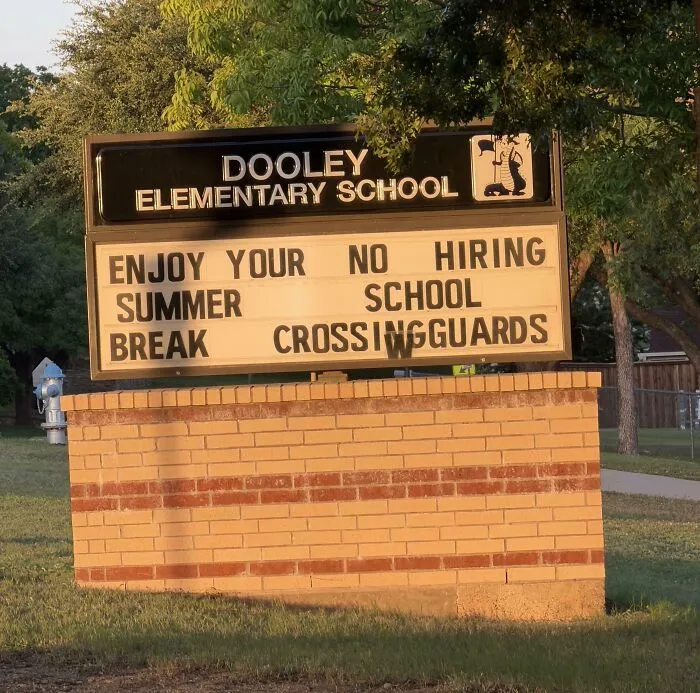 A school marquee sign with jumbled text layout, illustrating terribly designed signs.