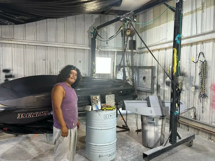A father standing in his workshop in wholesome pics of dads celebrating working hard for their family