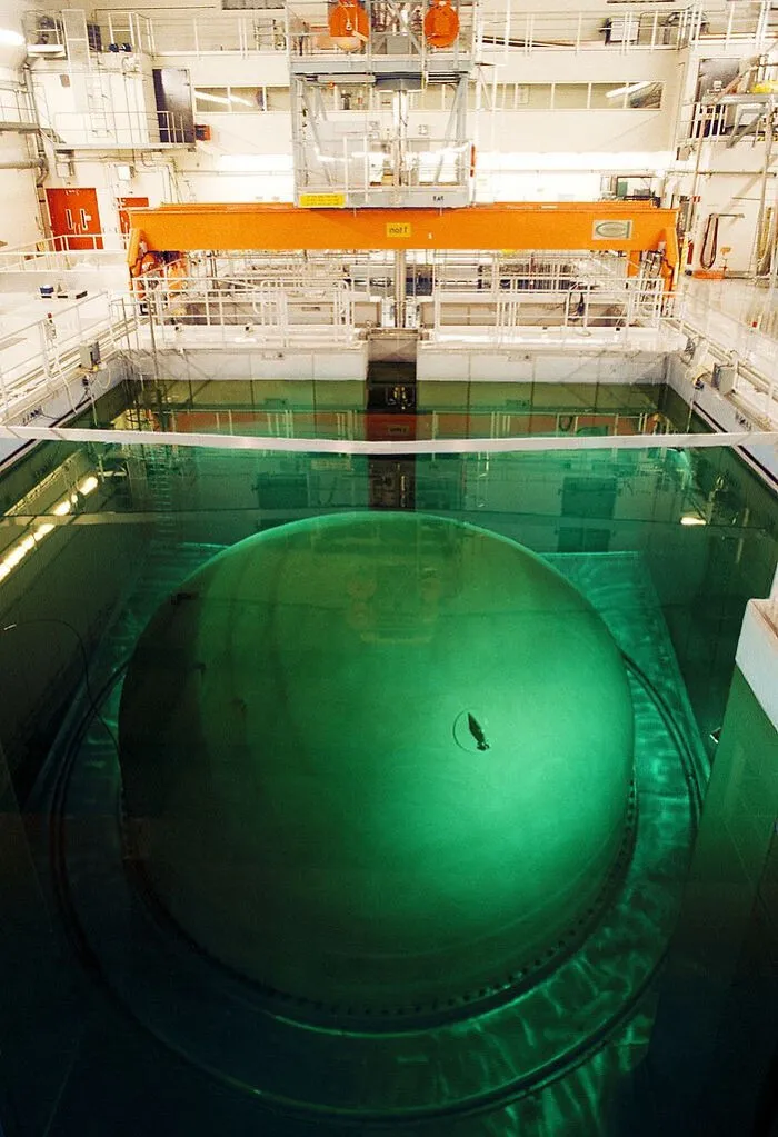 A massive green spherical structure underwater inside a facility, an unnerving example of submerged objects