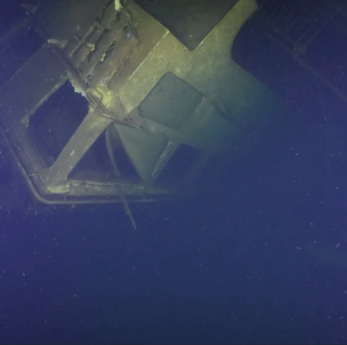 Dark underwater photo of a massive structure that depicts submechanophobia and submerged objects.