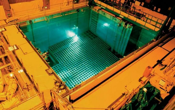 A large grid layout inside a spent fuel pool, showcasing submerged objects deep in an industrial water tank