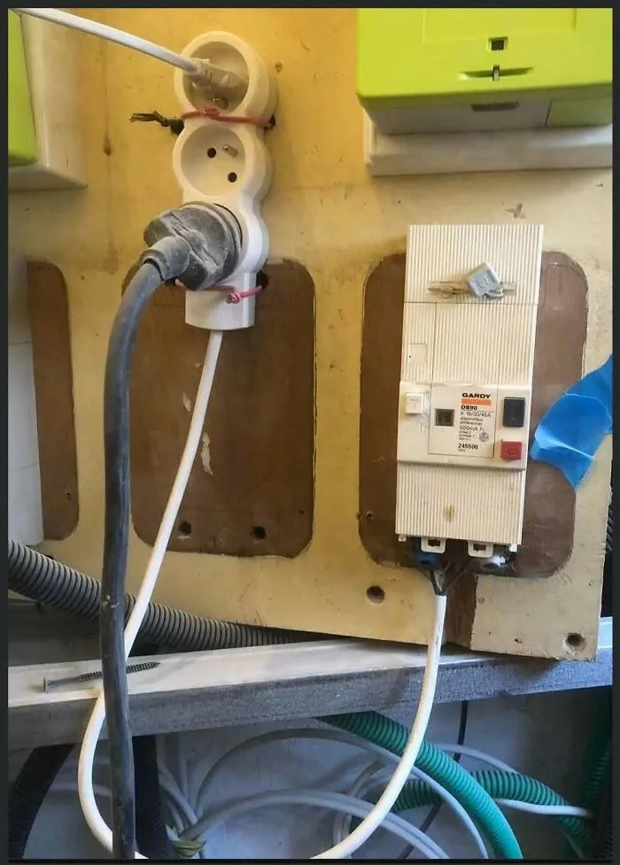 Unsafe electrical wiring and power outlet setup highlighting severe construction fails.