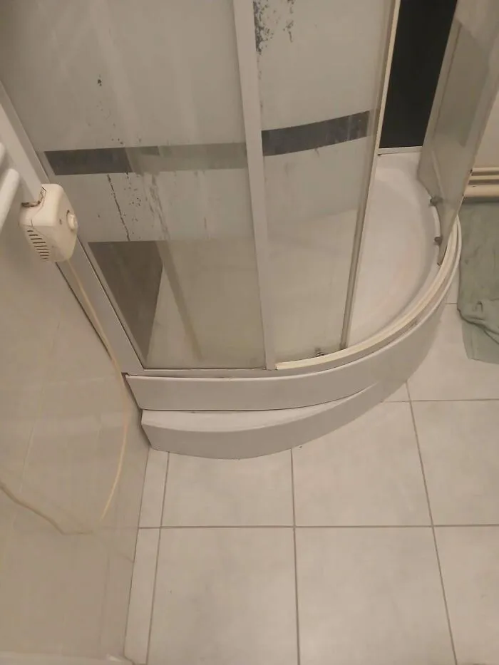 Poorly fitted shower unit in a bathroom as an example of construction fails.
