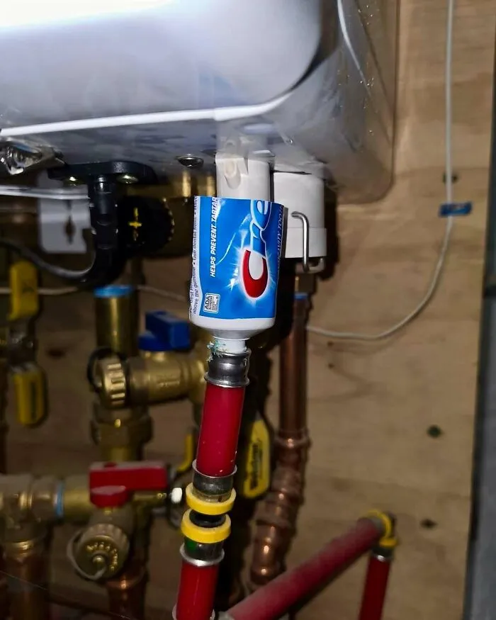 Absurd DIY plumbing construction fails using a Crest toothpaste tube cap as a pipe connector.