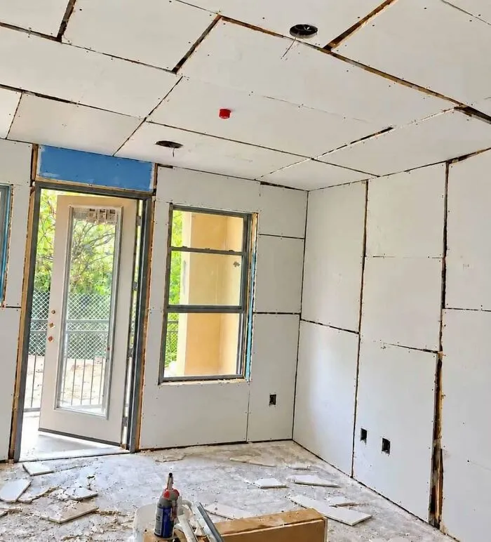 Unfinished interior drywall installation with uneven gaps showcasing major construction fails.