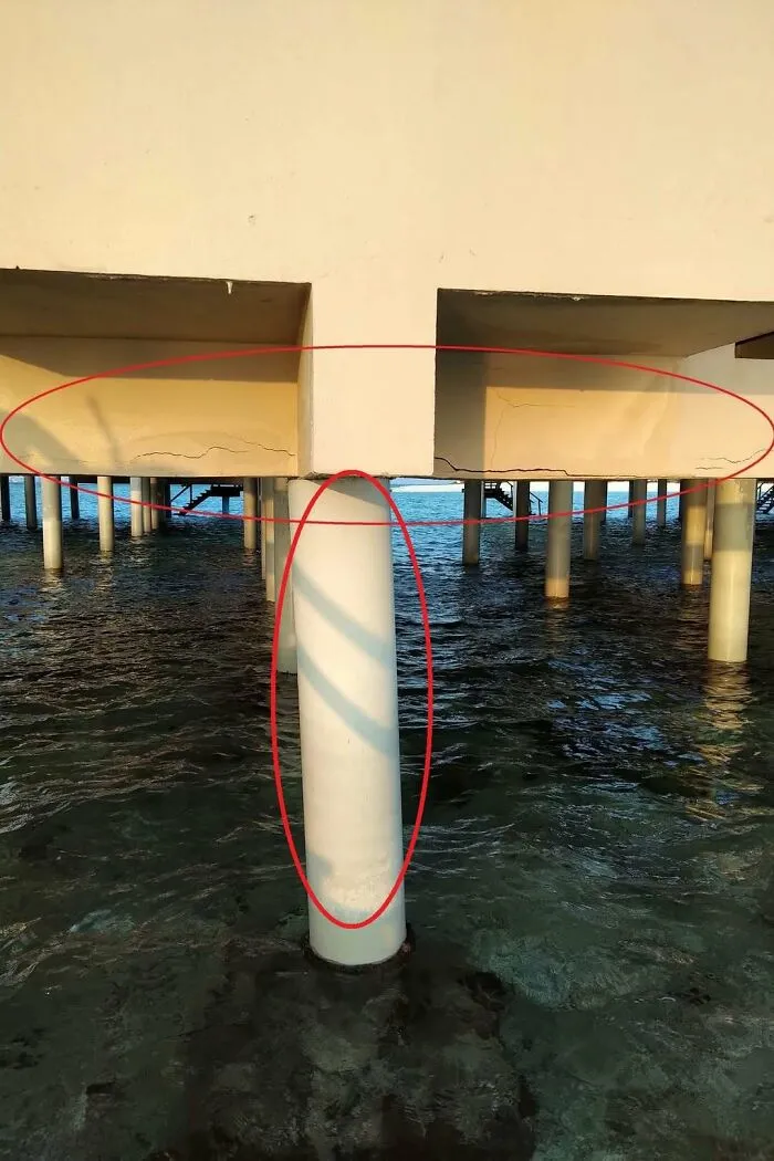 Cracks in a concrete pier support structure over water showing a major construction fail.