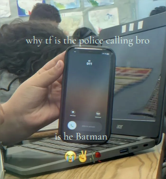A funny meme showing a phone receiving an incoming call from 911 resting on a laptop keyboard