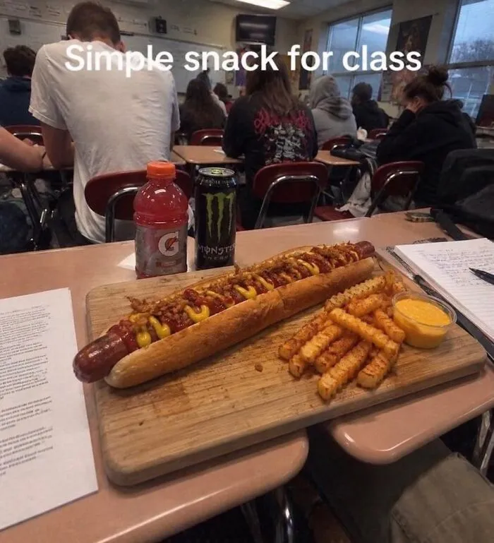 Giant hotdog and fries served on a desk in hilarious memes from real life.