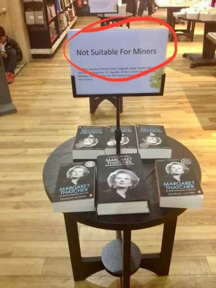 A bookstore display with a humorous sign about Margaret Thatcher books