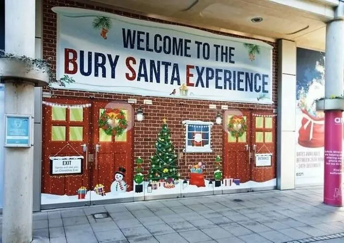 A festive entrance with a banner reading Welcome to the Bury Santa Experience, a sign that clearly missed the mark.