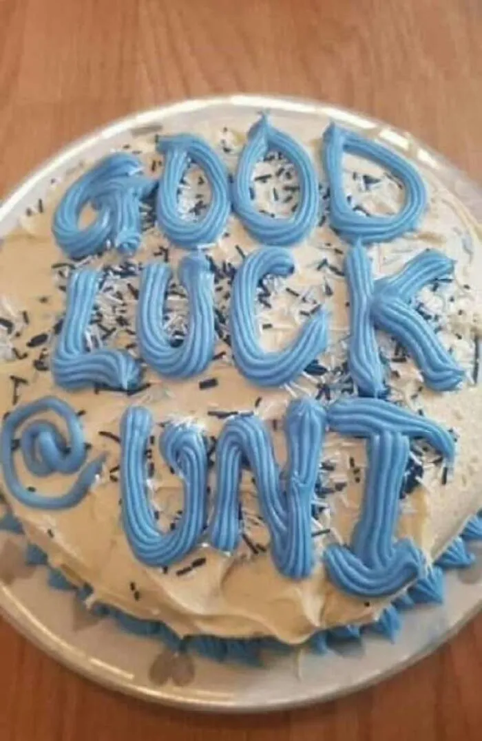 A cake decorated with blue icing that spells out an unfortunate phrase, representing a hilarious ad or message that missed the mark.