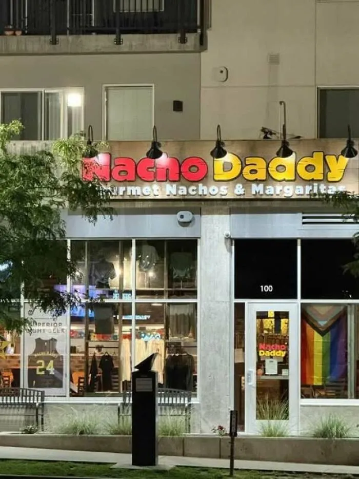A funny store sign for Nacho Daddy, showing a hilarious sign design fail