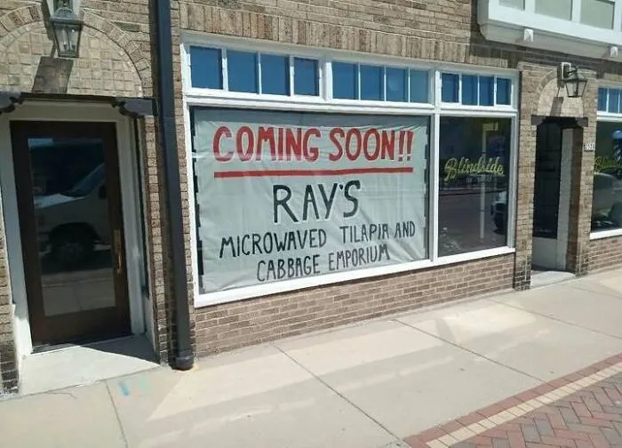 A storefront banner for Rays Microwaved Tilapia as a hilarious sign fail example