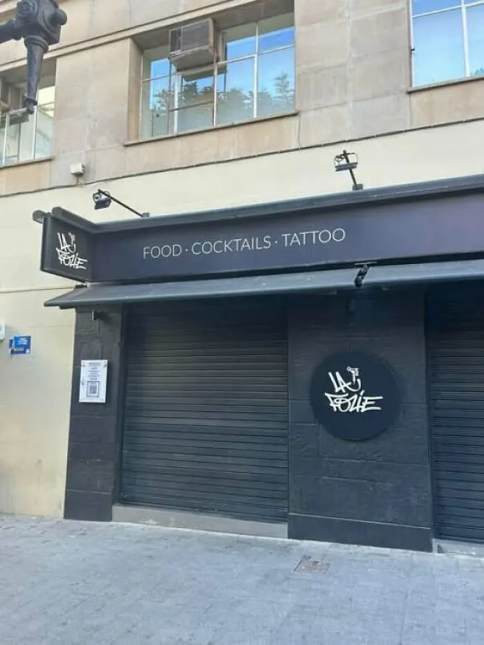 Hilarious storefront sign combining food, cocktails, and tattoo services under one roof