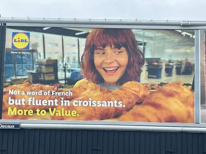 A supermarket billboard ad with unusual text phrasing serving as a hilarious ad.
