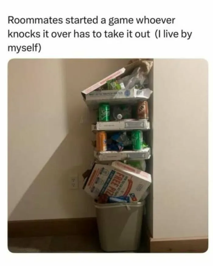 Strange and funny pics showing an extraordinarily tall stack of trash filled to the ceiling over a small bin.