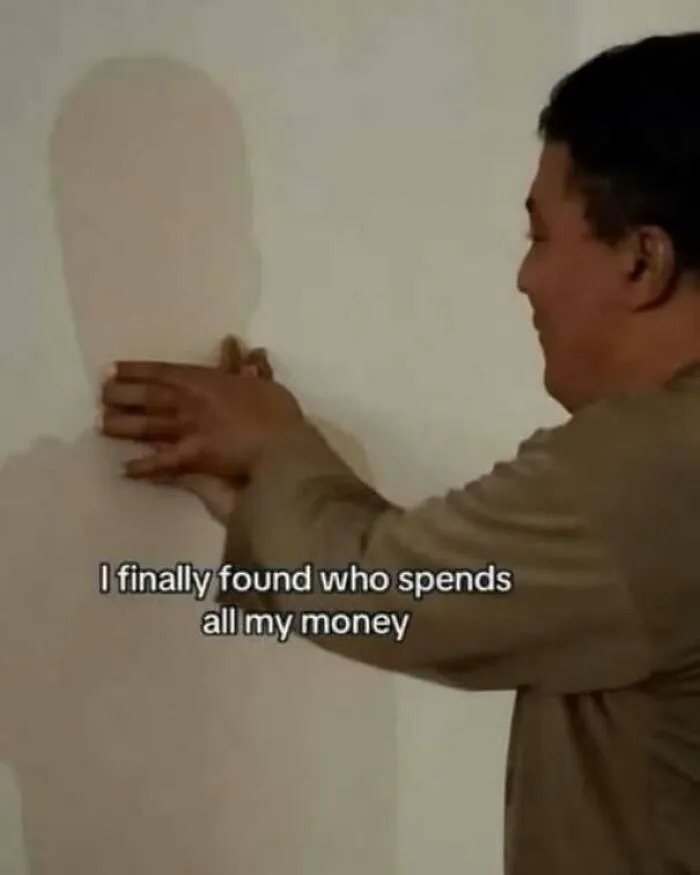 Funny pics meme of a man grabbing his own shadow on a wall