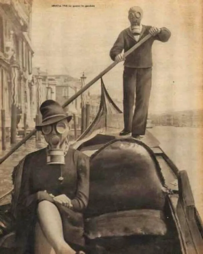 Old photo of people wearing gas masks on a gondola in Venice