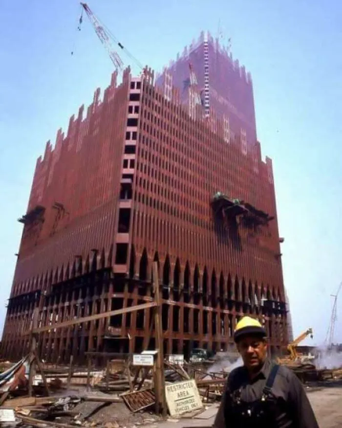 Under construction view of a large historic skyscraper with workers
