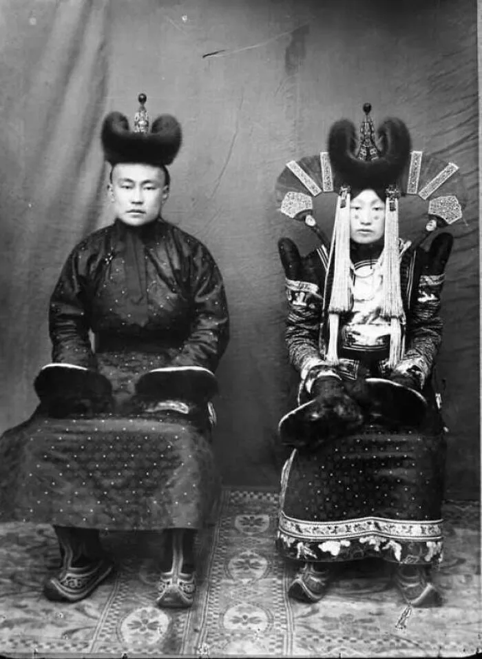 Black and white photo of a historical couple wearing traditional attire and headdresses