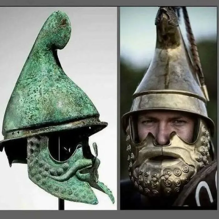 Ancient bronze helmet with detailed facial features from historical archaeological discovery