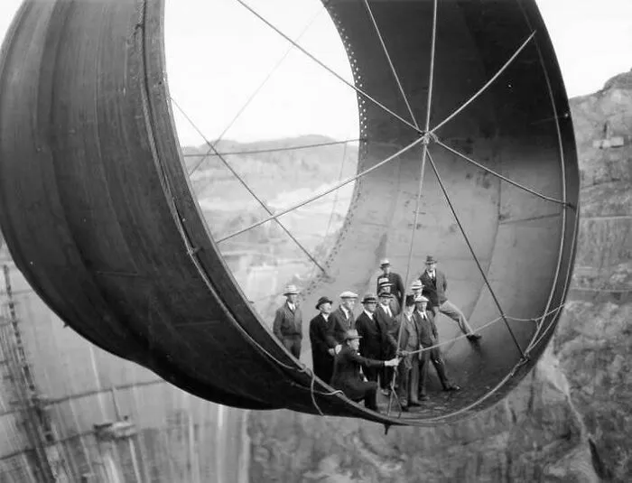 Historic construction workers inside giant concrete bucket at Hoover Dam site