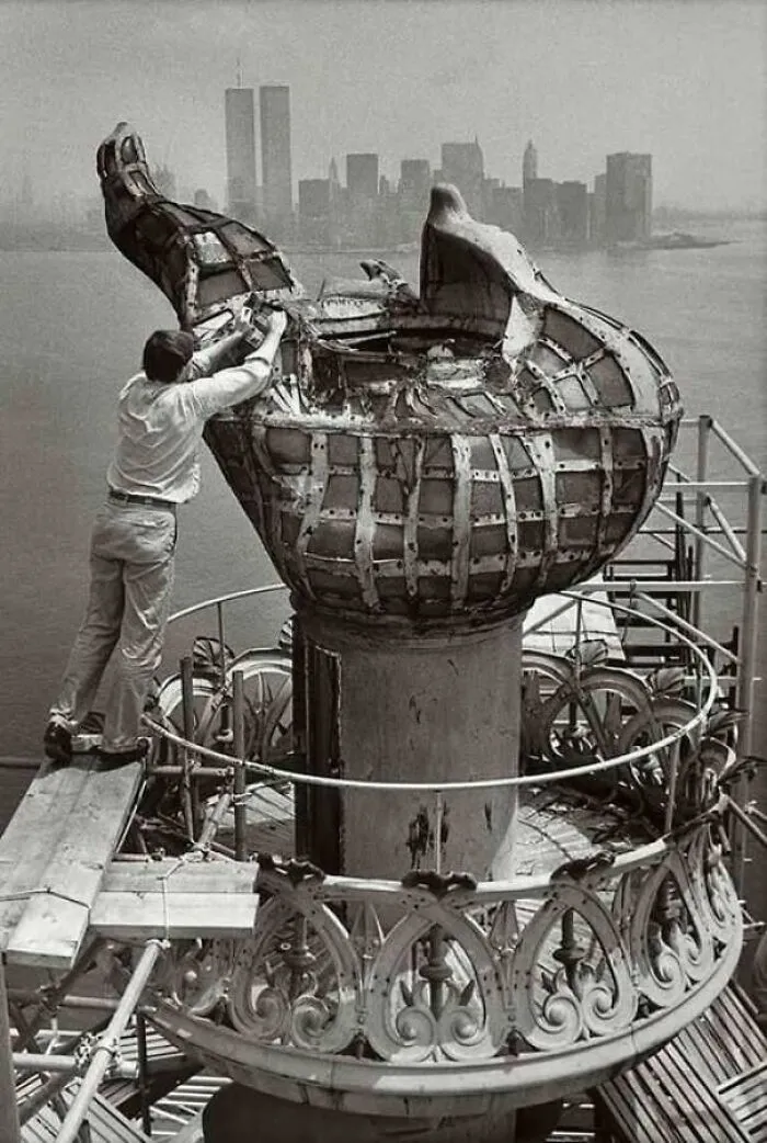 Restoration of the Statue of Liberty torch with New York skyline in background historic landmark