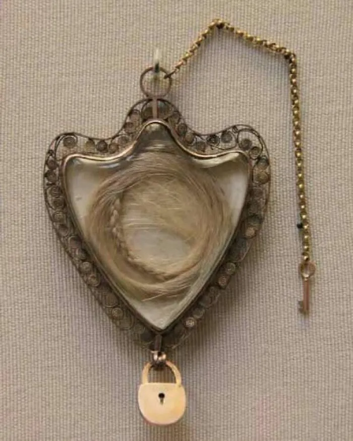 Victorian-era hair lock inside a decorative locket with small key