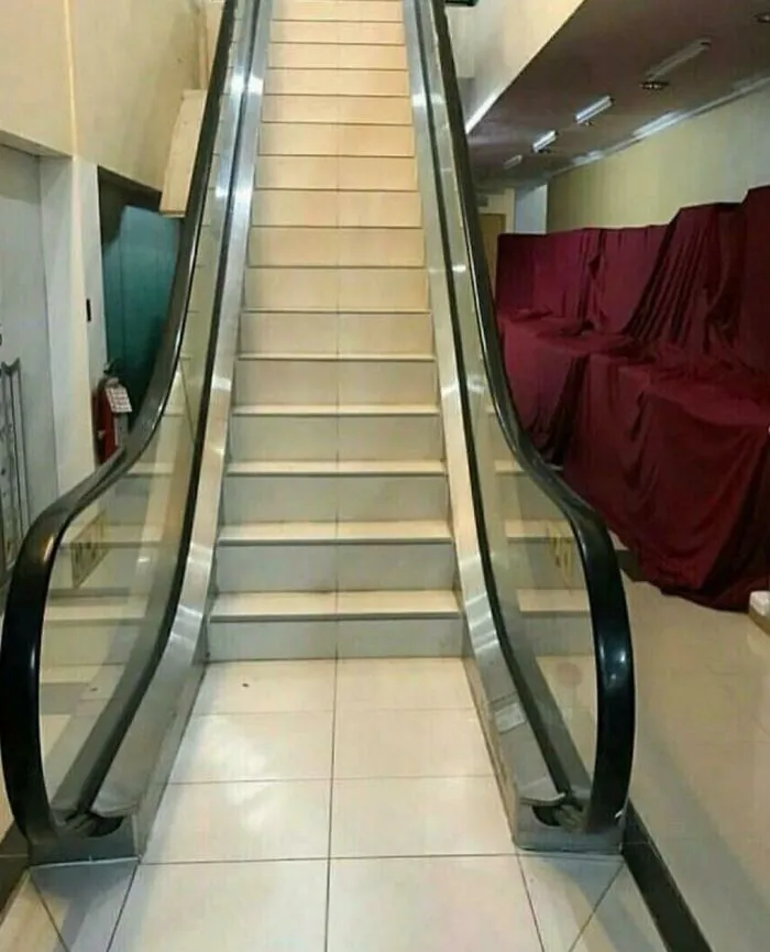 Escalator frame fitted with regular tiled staircase steps illustrating bizarre Slavic engineering.