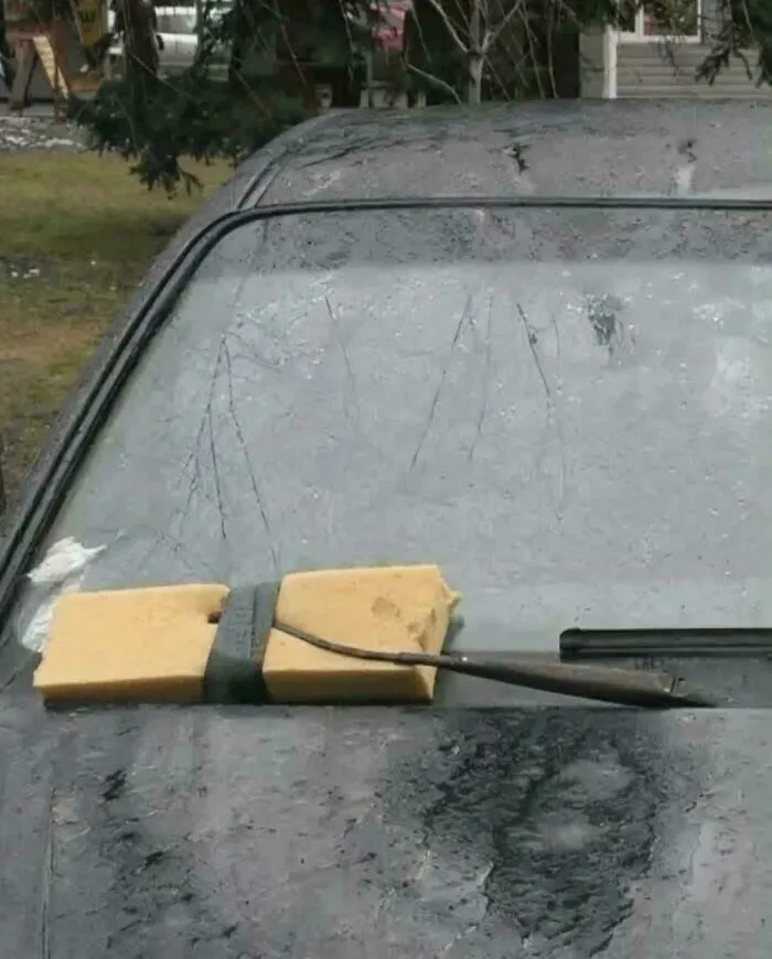 A windshield wiper repaired with a sponge, demonstrating makeshift Slavic engineering.