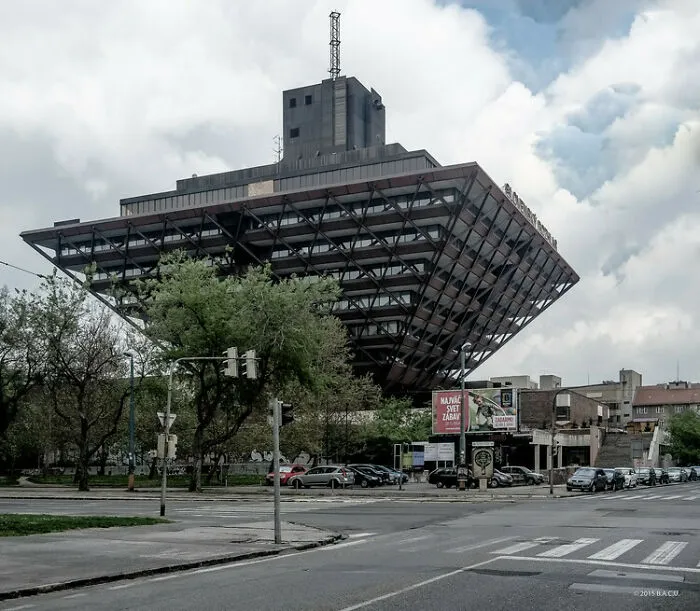 Slavic engineering marvel featuring a massive upside-down pyramid building over a street.