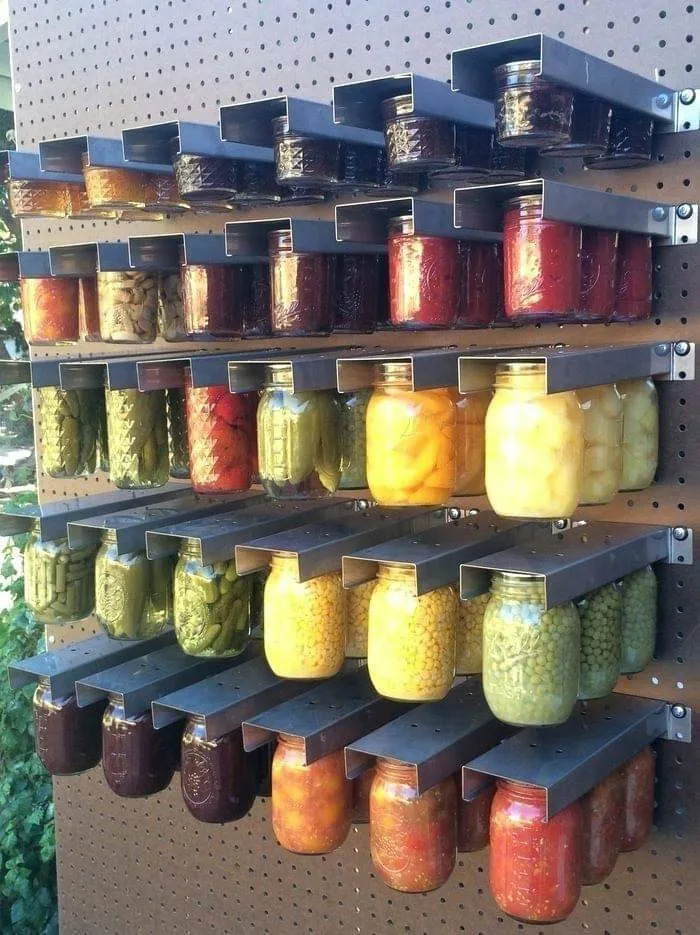 Clever Slavic engineering showing jarred food organized on custom metal wall mounts.