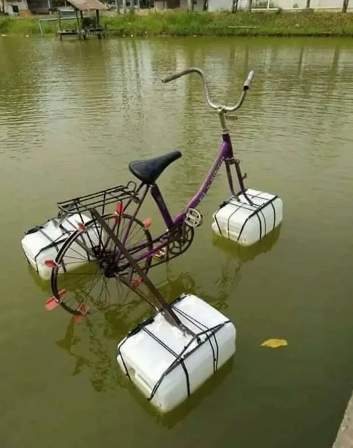 A handmade amphibious bike with plastic jug floats, showcasing unique Slavic engineering on water.