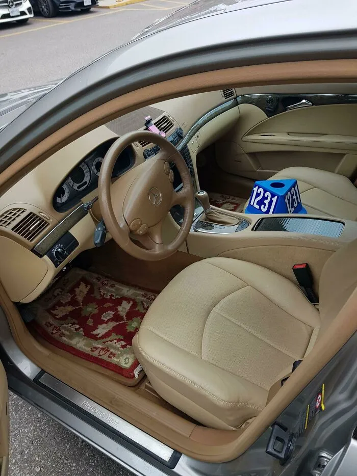 Slavic engineering seen in a luxury car interior outfitted with a traditional woven floor rug.