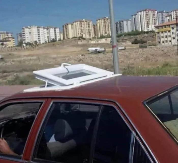 Example of Slavic Engineering featuring a car installed with a house window frame as a sunroof.