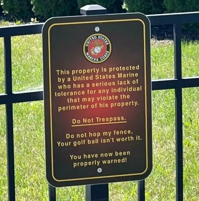 Sign warning trespassers property protected by a Marine with low tolerance