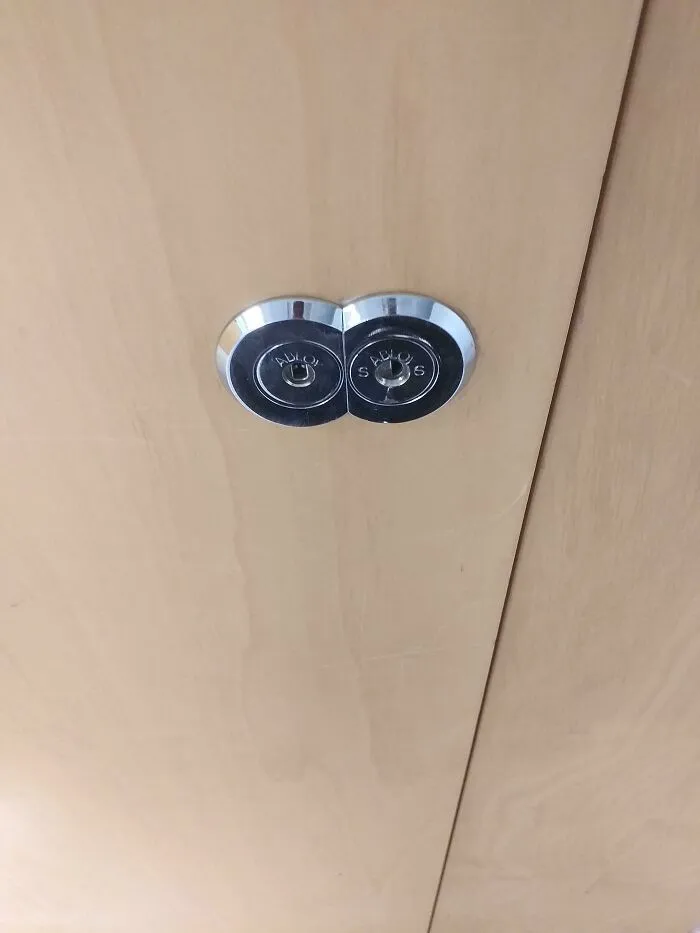 Two door locks placed so closely they almost overlap in ridiculous design