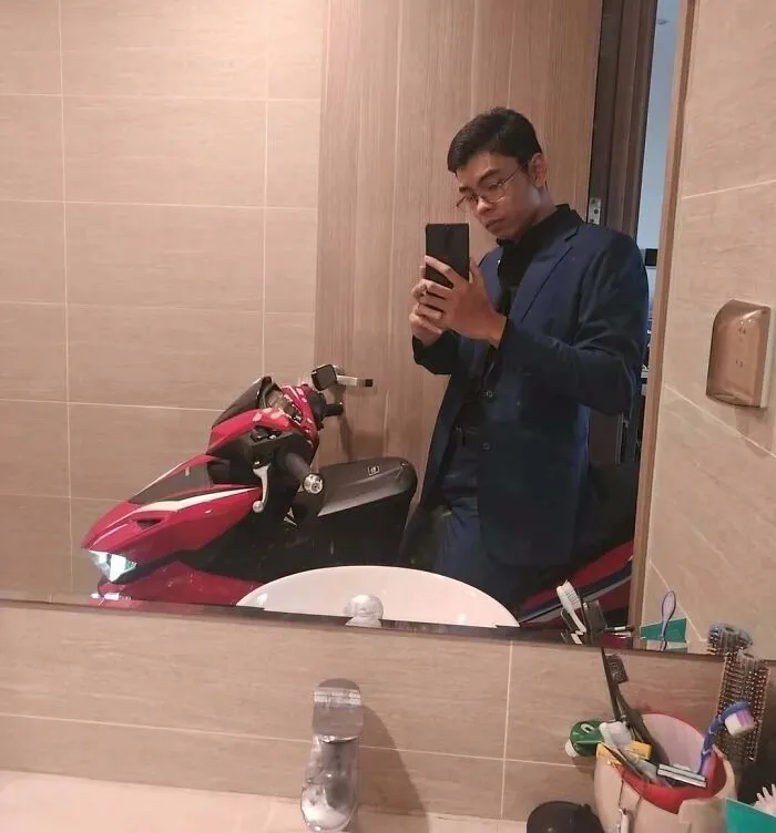 Hilarious pics of a man taking a bathroom selfie with a red motor scooter