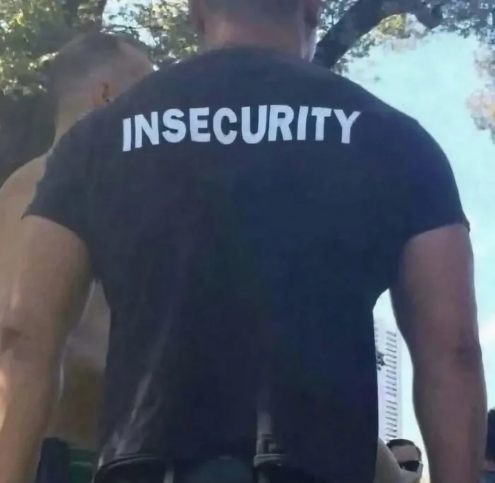 A hilarious pic of a man wearing a shirt that says INSECURITY on the back.