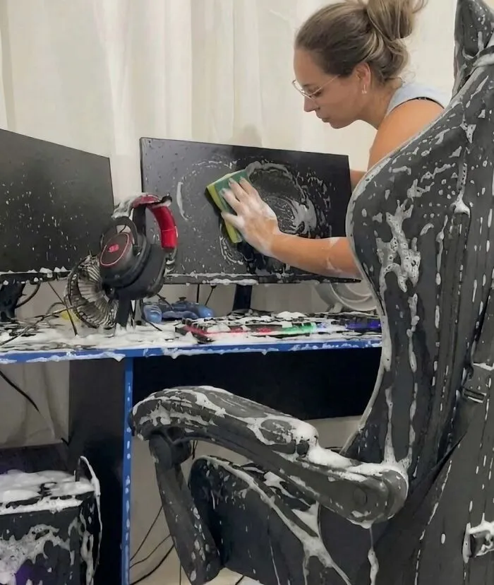 Hilarious pics of a woman washing a complete computer setup and gaming chair with soapy water