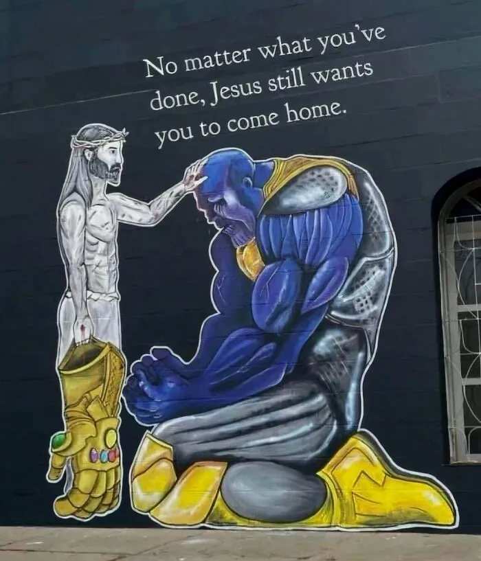 Hilarious pics showing a wall painting of Jesus comforting a kneeling Thanos.