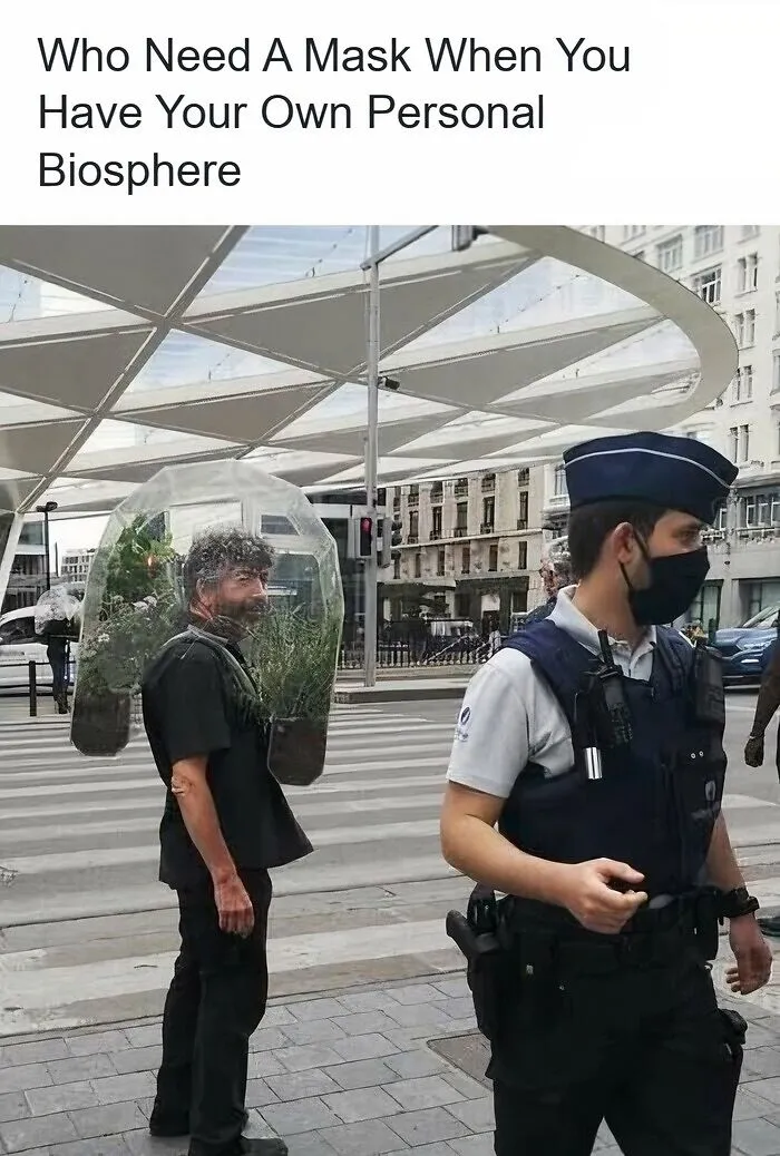 Funny pics of a man wearing a wearable plant biosphere bubble on a city street.