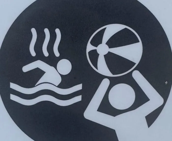 Black and white sign with unclear hot water and ball throwing icons