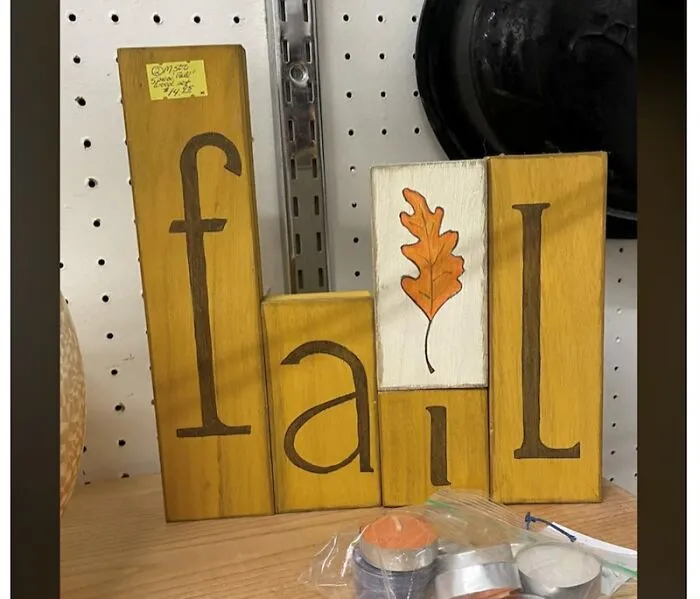 Wooden blocks spelling fail with misplaced letters and leaf art