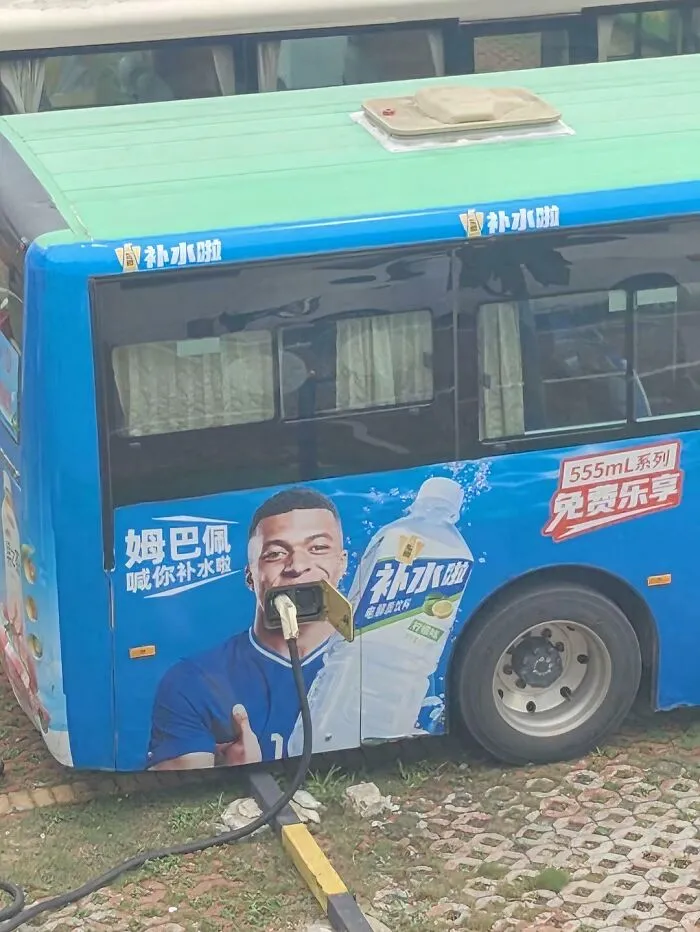 Bus charging point positioned to block advertisement design on bus side